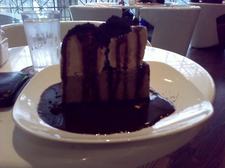 a piece of chocolate cake on a small white plate