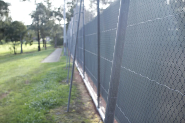 a po of a fence with a view of the grass in the background