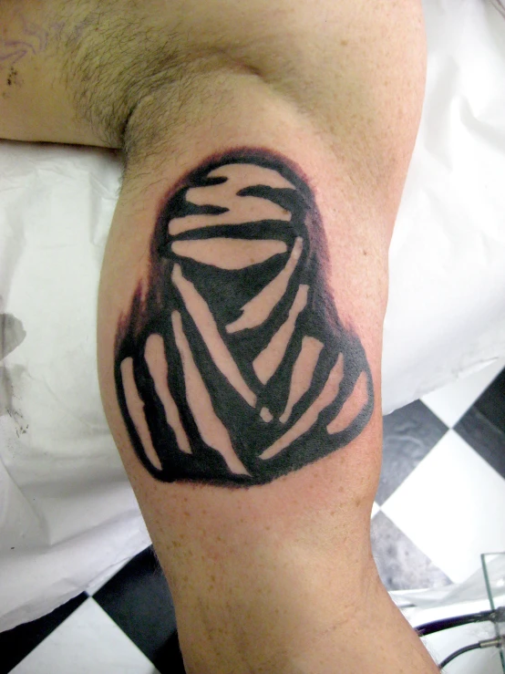 tattoo art on man arm depicting black and white image