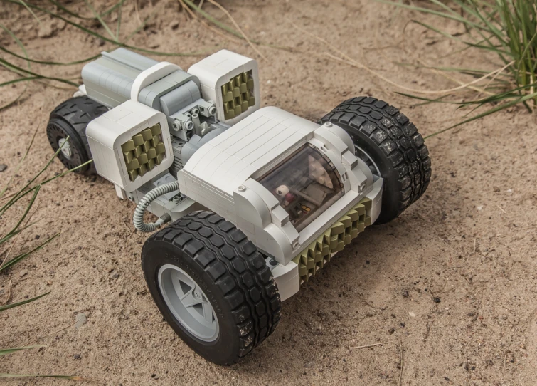 a lego car parked in the middle of the sand