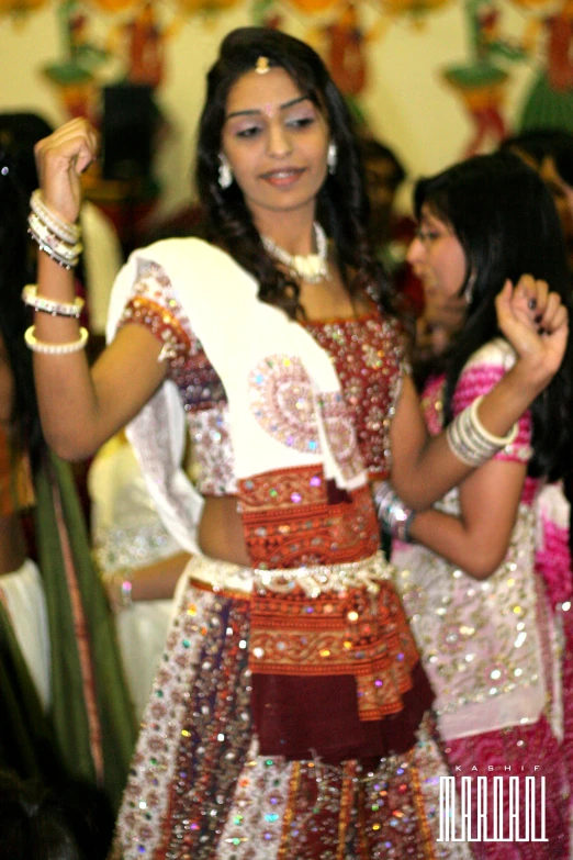 an indian woman in a costume dancing with other women