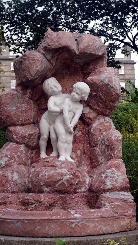 a statue of two people sitting next to each other