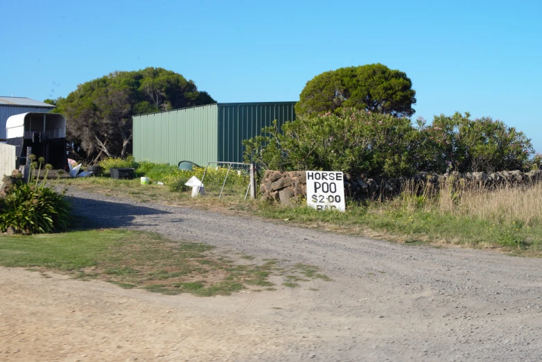 a dirt road that is going to an industrial area