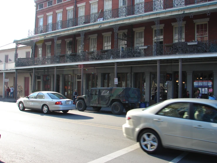 a car and a truck traveling past a building