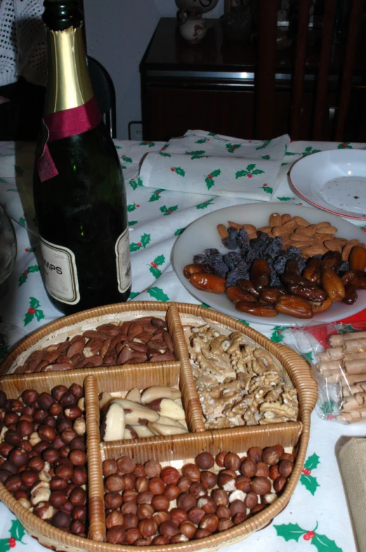 an assortment of snacks in wicker baskets next to champagne bottle