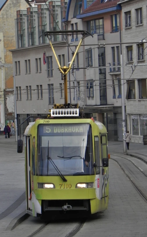 an electric trolley traveling through the city streets