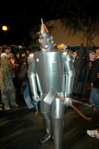 the person is in a knight costume with many people standing around