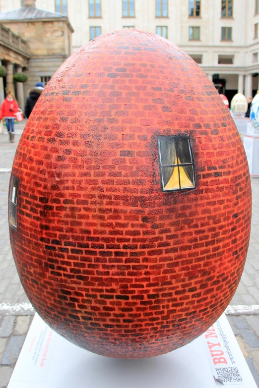 a large sphere on display in front of a building