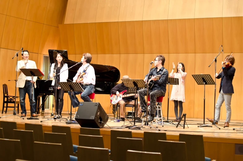 a group of people in concert playing instruments