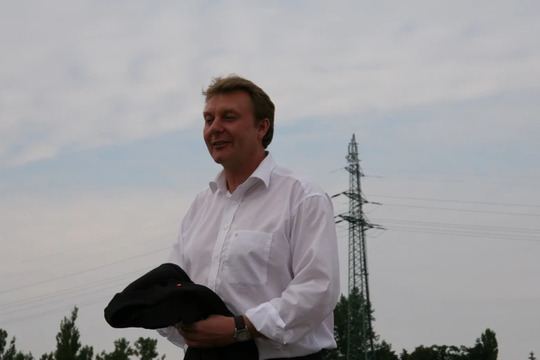 a man holding up a hat that has a white collar