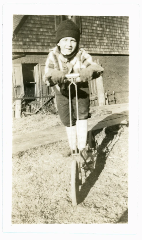 old black and white pograph of an elderly lady riding her small skateboard