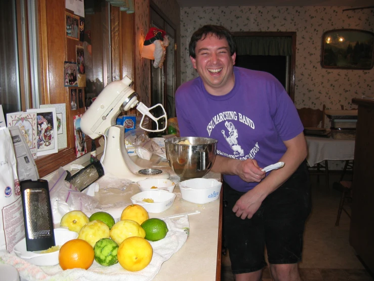 man standing in front of kitchen counter holding a knife