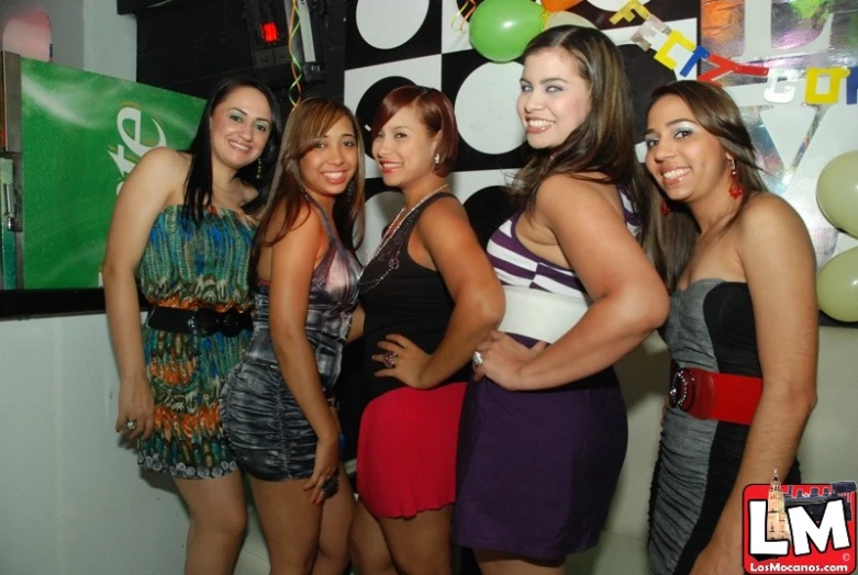 a group of women are standing together smiling for a po