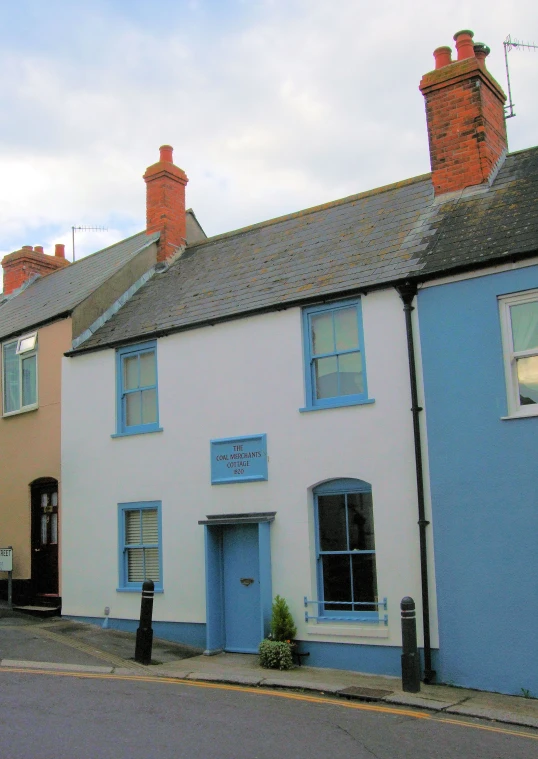 many small houses along the street with brick chimneys