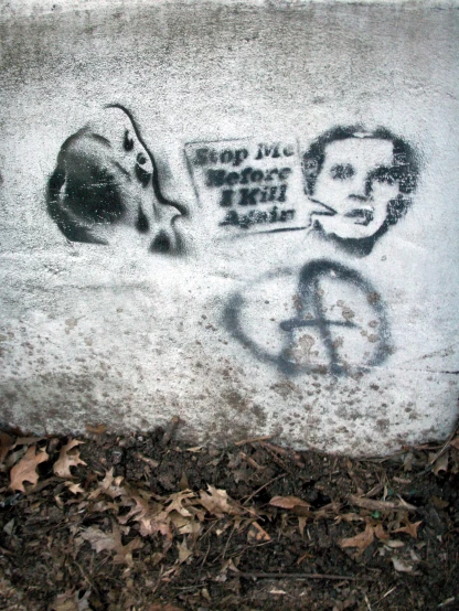 a piece of graffiti depicting a man's face and another handwritten message