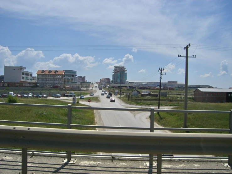 a city street with a few cars going down the road