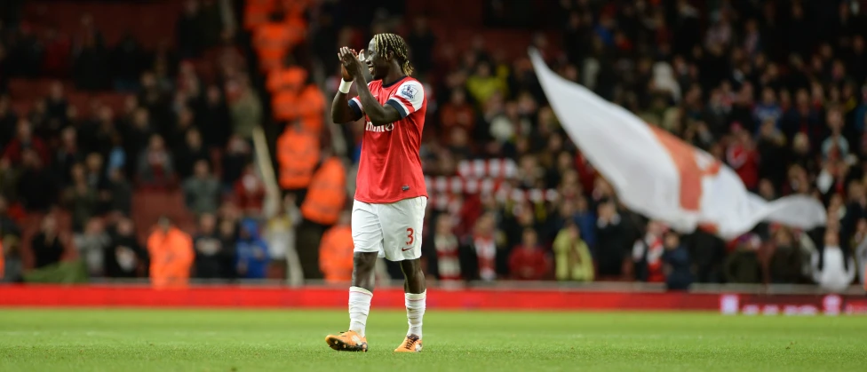 a soccer player waves his fist during a game