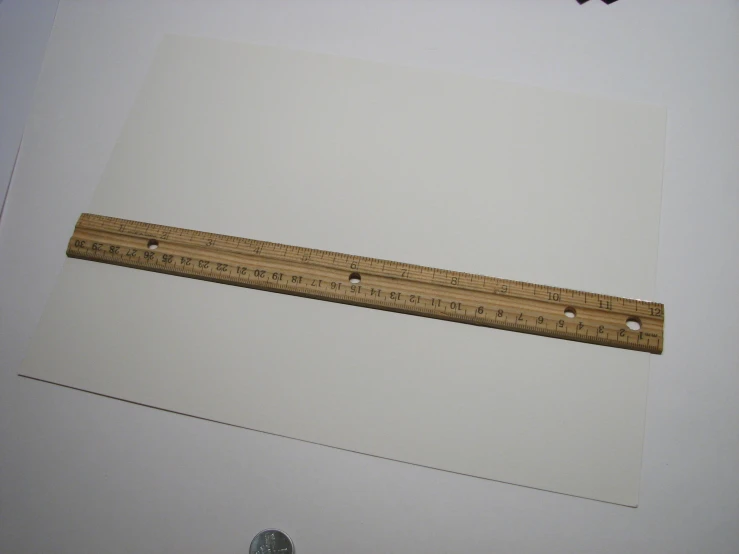 rulers with holes sit on a white table