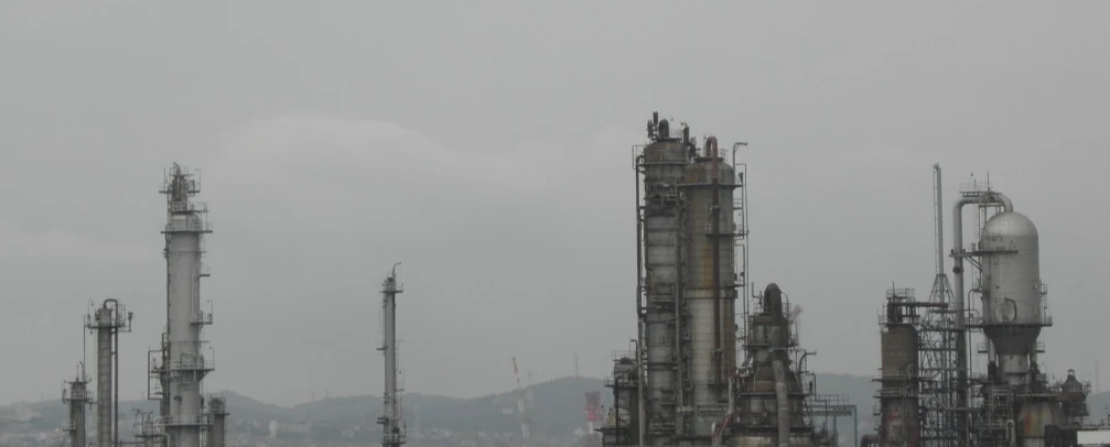 a large group of refinerys and smoke stacks on an industrial area