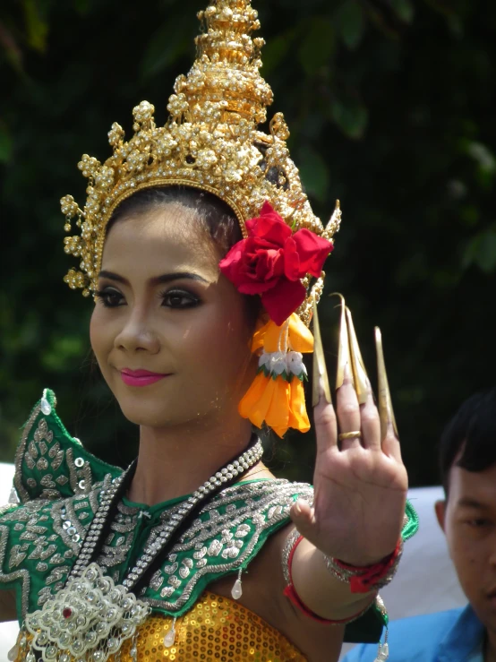 an asian woman wearing a costume with flowers on her head