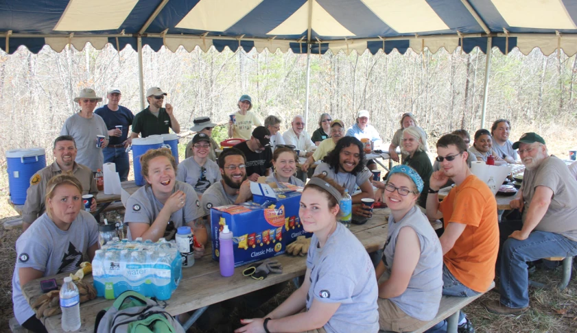 a group of people sitting at a table with water bottles