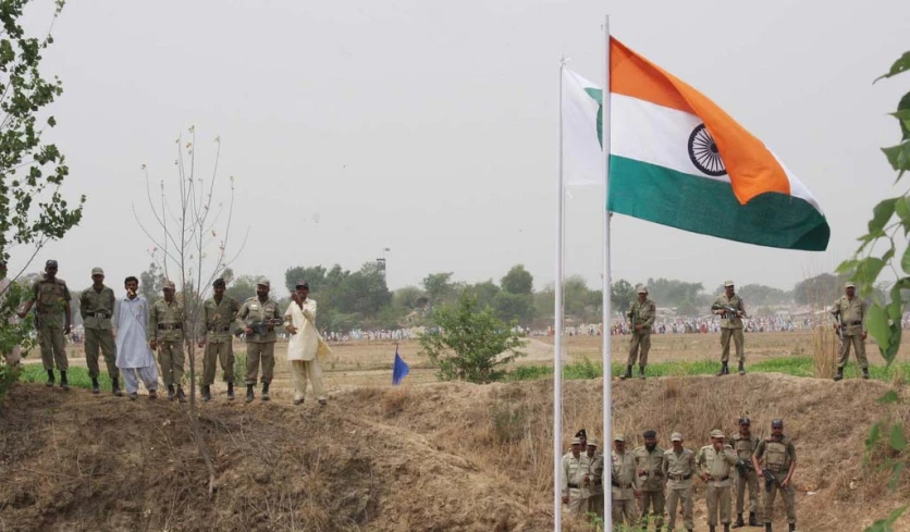 indian soldiers on the field in front of indian flag