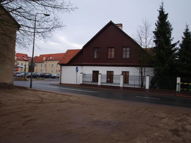 a white and brown house near a street