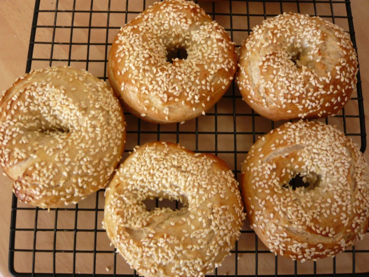 four buns are cooling on a cooling rack