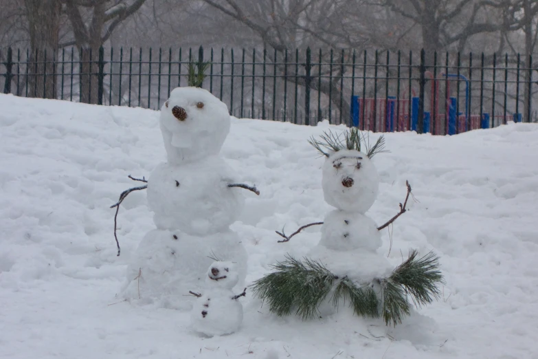 snowmen have been constructed with little evergreen sprigs