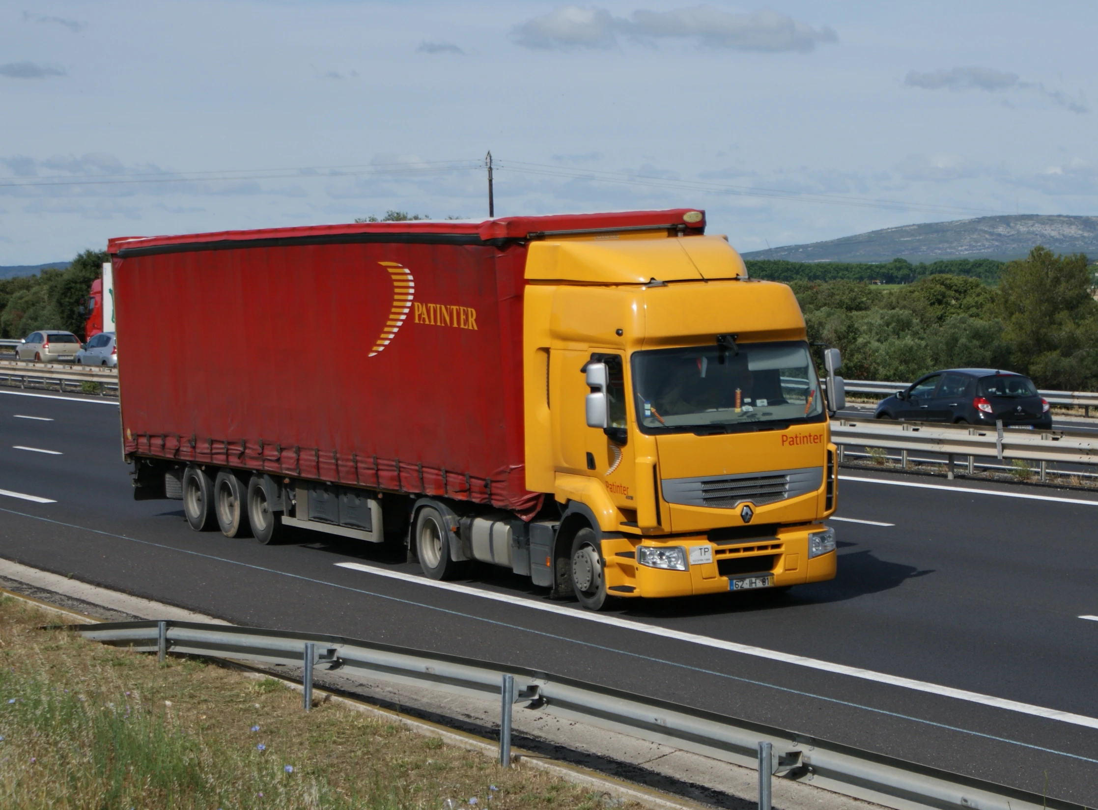 a semi is shown driving down the road