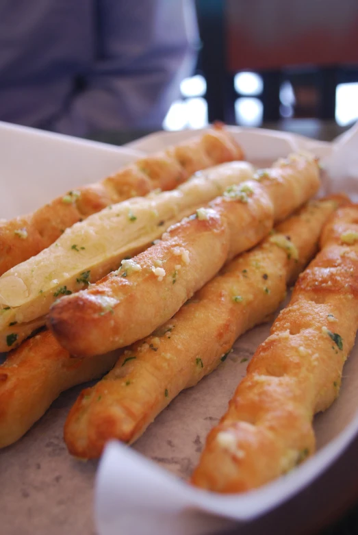 some cheesy looking bread sticks in a bowl