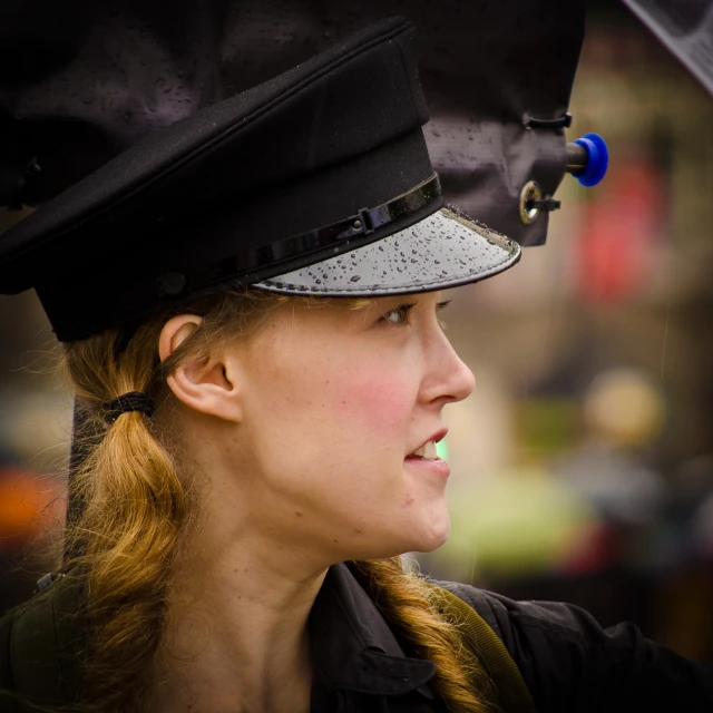 a woman that is wearing a black hat