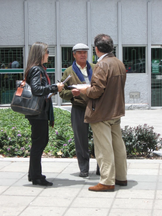 people standing together in front of a building