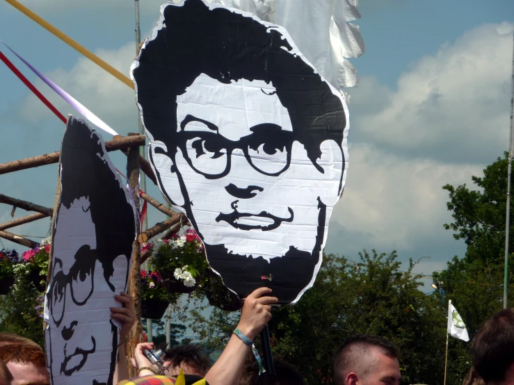 a protest of an obama with a man's face painted on it