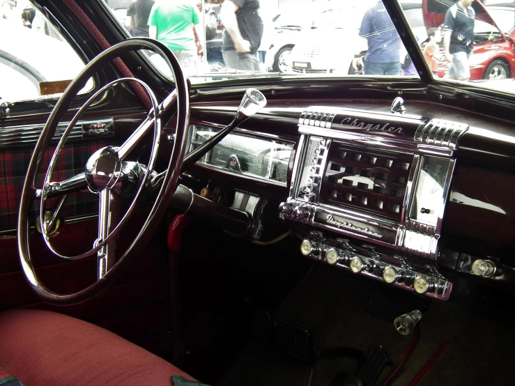 the interior of an old car and some people in the background