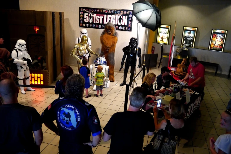 a scene from the star wars show of actors on stage with a group of children dressed in costumes