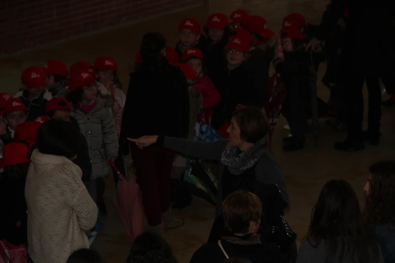 several women with red hats are standing around