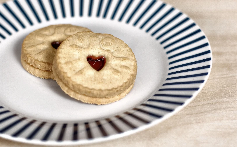 two cookies with chocolate on top are arranged in a plate