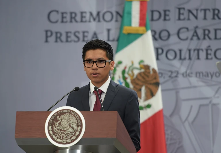 a man stands at a podium and makes a speech