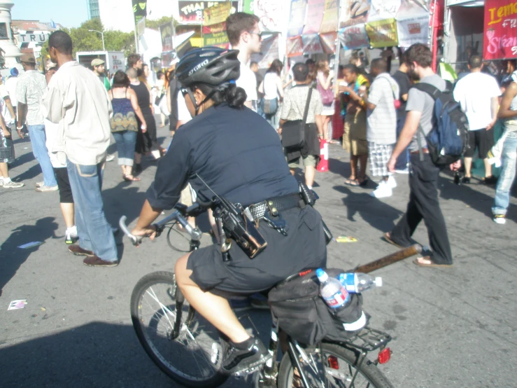 the man rides his bike through the busy market