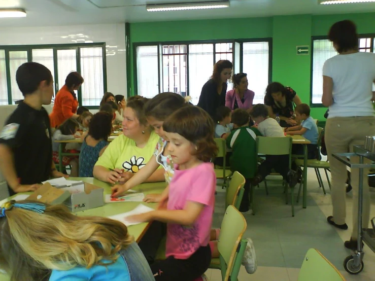 children sitting at their lunch boxes in a classroom