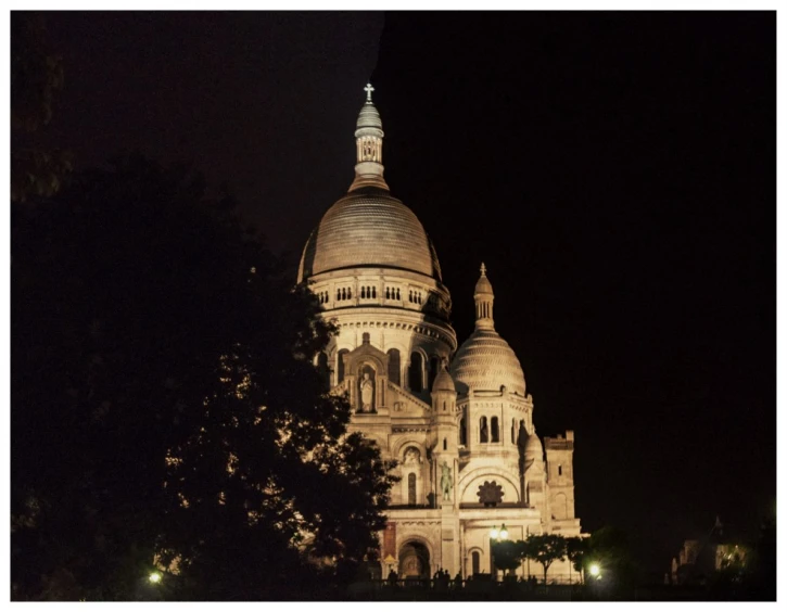 a very old building lit up at night with lights on