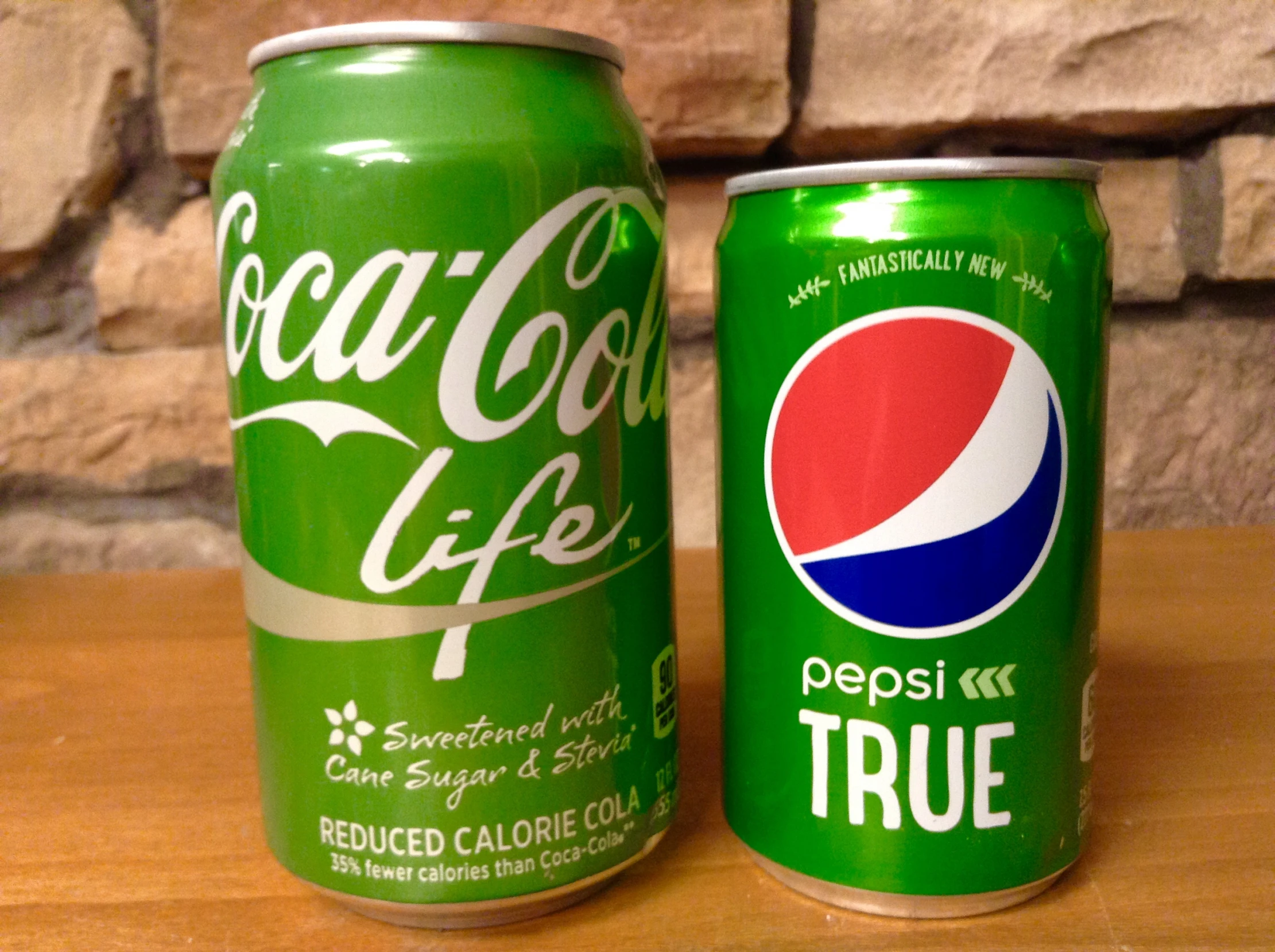 there is a can of soda next to another can