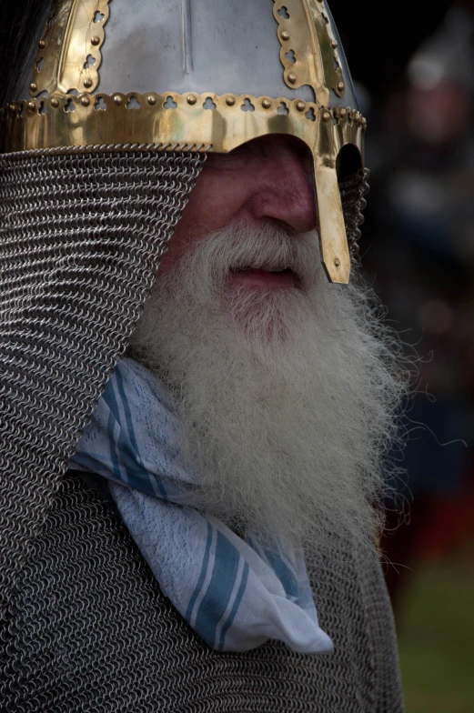 a man in an elaborate helmet with silver and blue stripes