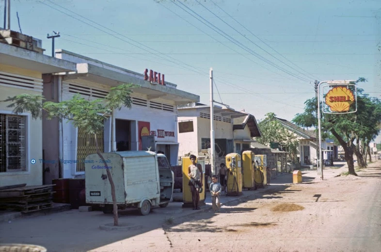 the yellow and black utility trucks are parked outside of the small businesses