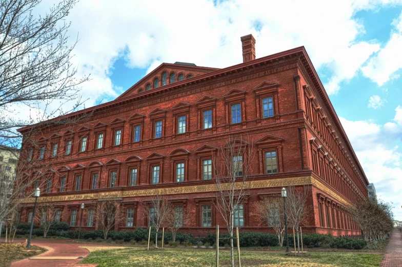 a red brick building with windows in the shape of a triangular