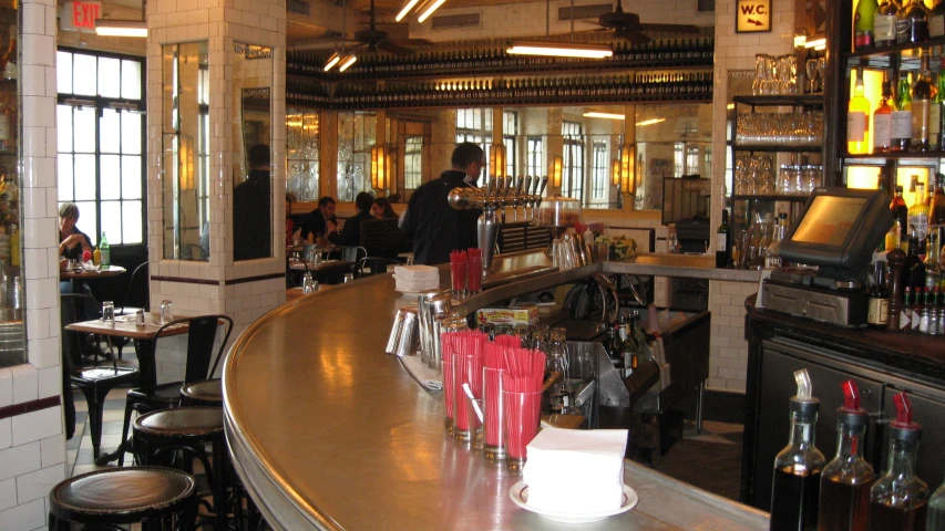 a bar with a group of people standing behind it