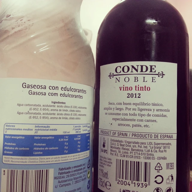 two bottles of wine sitting side by side