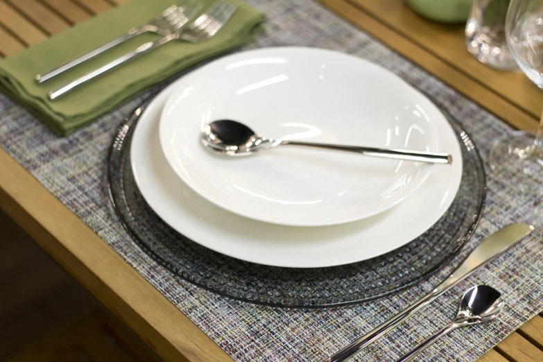 a white and black plate with silverware on top of it