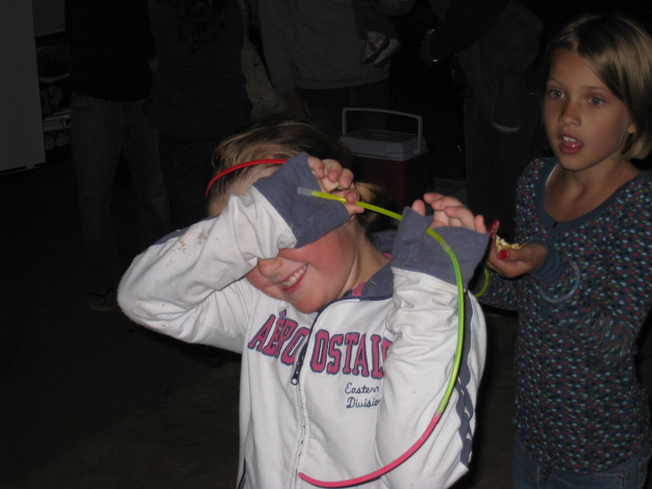 two children with plastic forks in their mouths